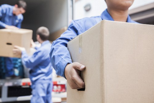 Professional removal team handling moving boxes in South Kensington