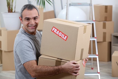 Moving team handling boxes safely during a South Kensington van service