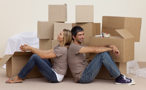 Professional movers loading furniture into a removal truck in Southkensington