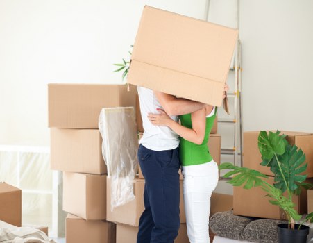 Staff member using PPE while loading furniture into a removal van
