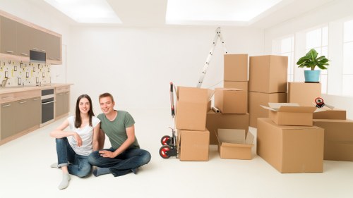 Business movers handling furniture and IT assets during an office move